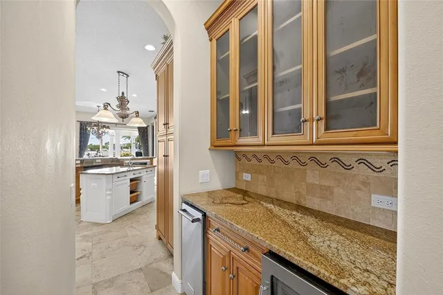 a living room with lots of furniture and view of kitchen