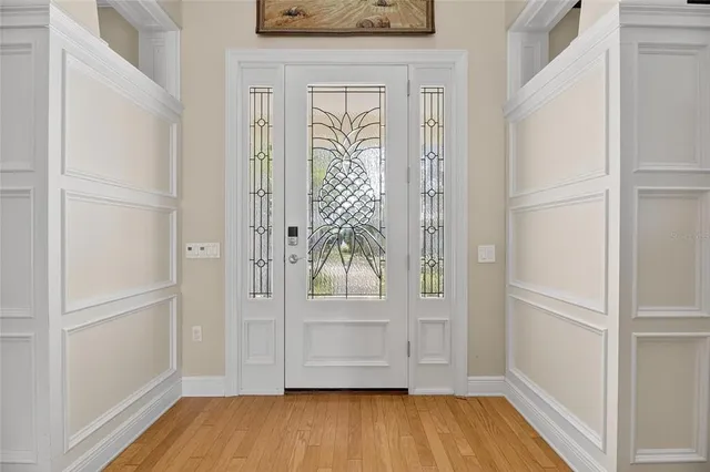 a view of a livingroom with wooden floor and a chandelier