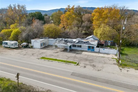 an aerial view of a house with a garden and lake view