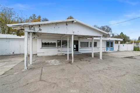 a view of a house with a patio and a yard