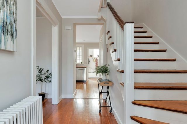 a view of entryway with wooden floor and stairs
