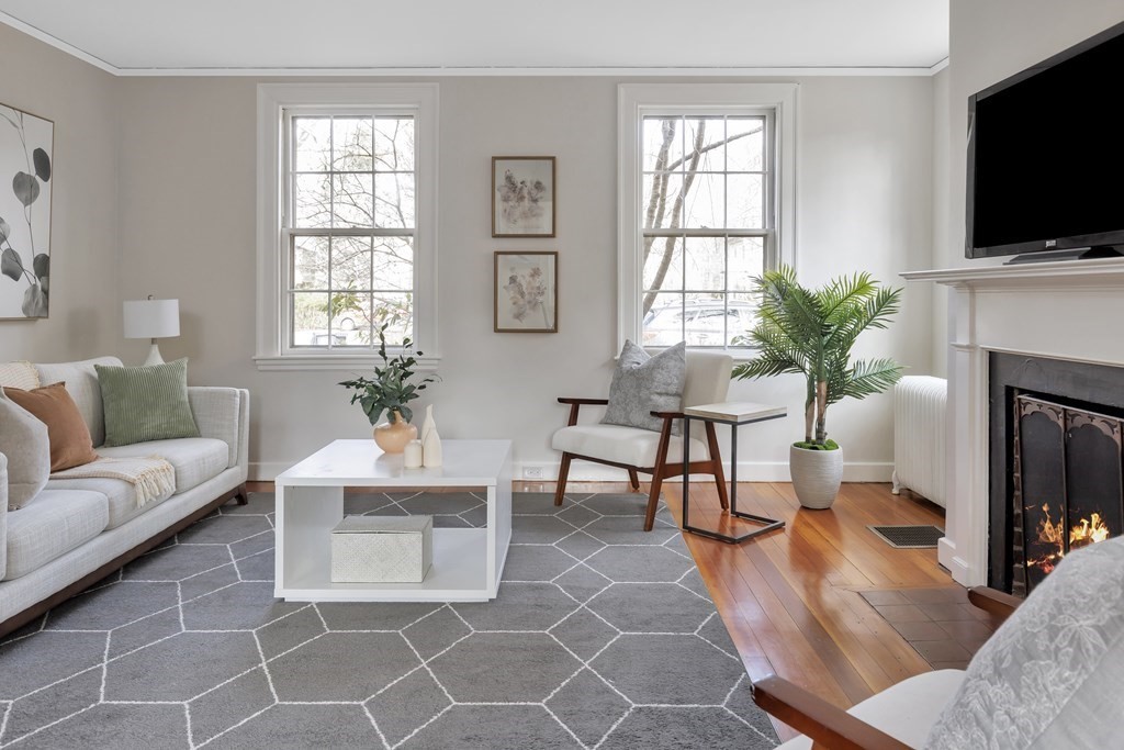10 Shady Hill Square Cambridge, MA 02138 - Photo 2 of 37 a living room with furniture a flat screen tv and a fireplace