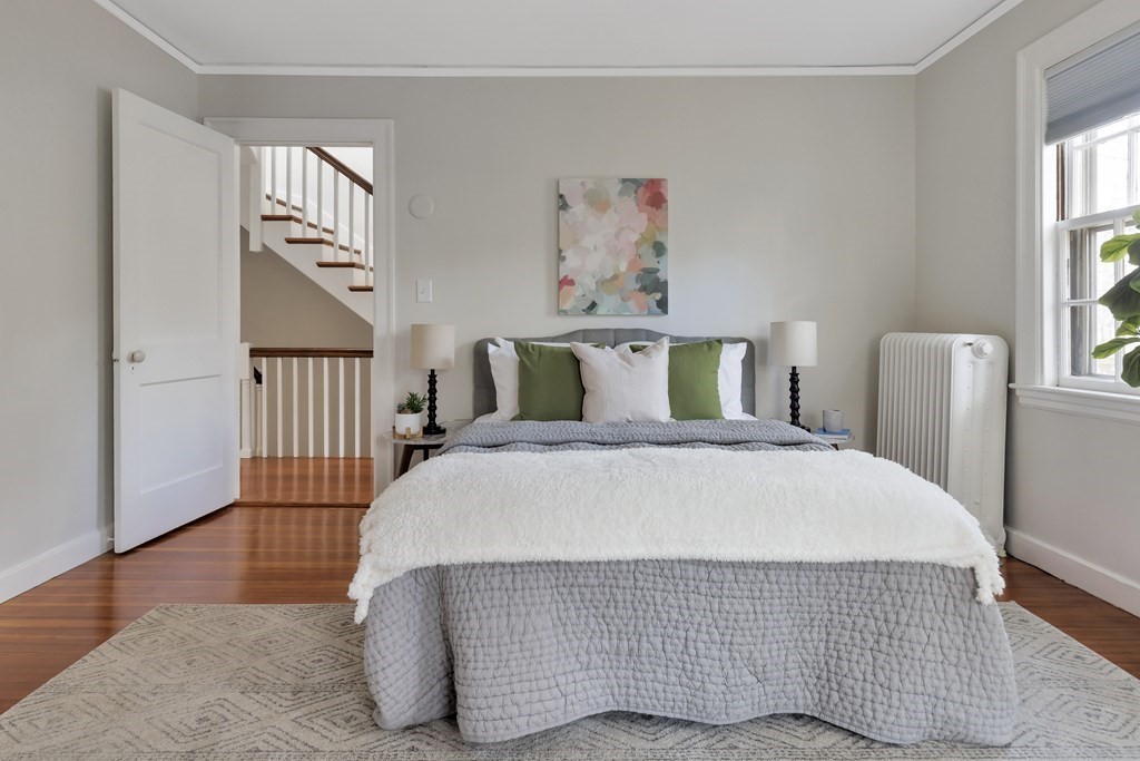 10 Shady Hill Square Cambridge, MA 02138 - Photo 21 of 37 a bedroom with a bed and wooden floor