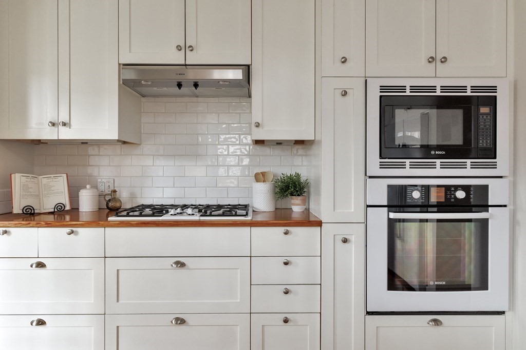 10 Shady Hill Square Cambridge, MA 02138 - Photo 9 of 37 a kitchen with stainless steel appliances granite countertop white cabinets and stove