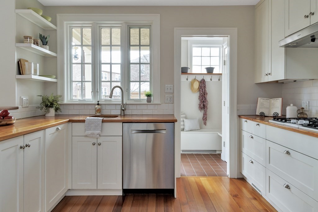 10 Shady Hill Square Cambridge, MA 02138 - Photo 10 of 37 a kitchen with white cabinets and wooden floors