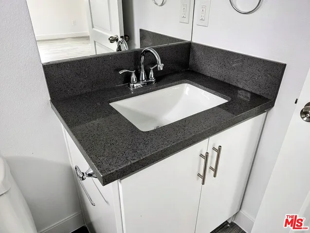 a kitchen with a sink and a refrigerator