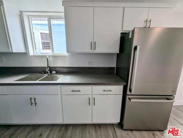 a white refrigerator freezer sitting inside of a kitchen