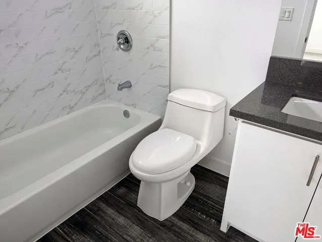 a bathroom with a toilet and a bathtub
