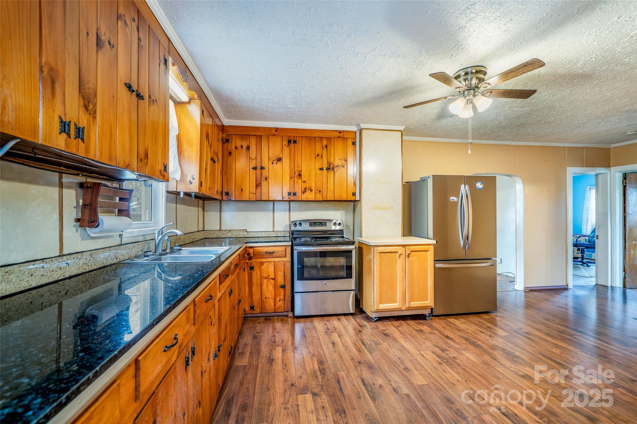 298 School Road East Asheville, NC 28803 - Photo 11 of 27 a kitchen with stainless steel appliances granite countertop wooden floors and sink