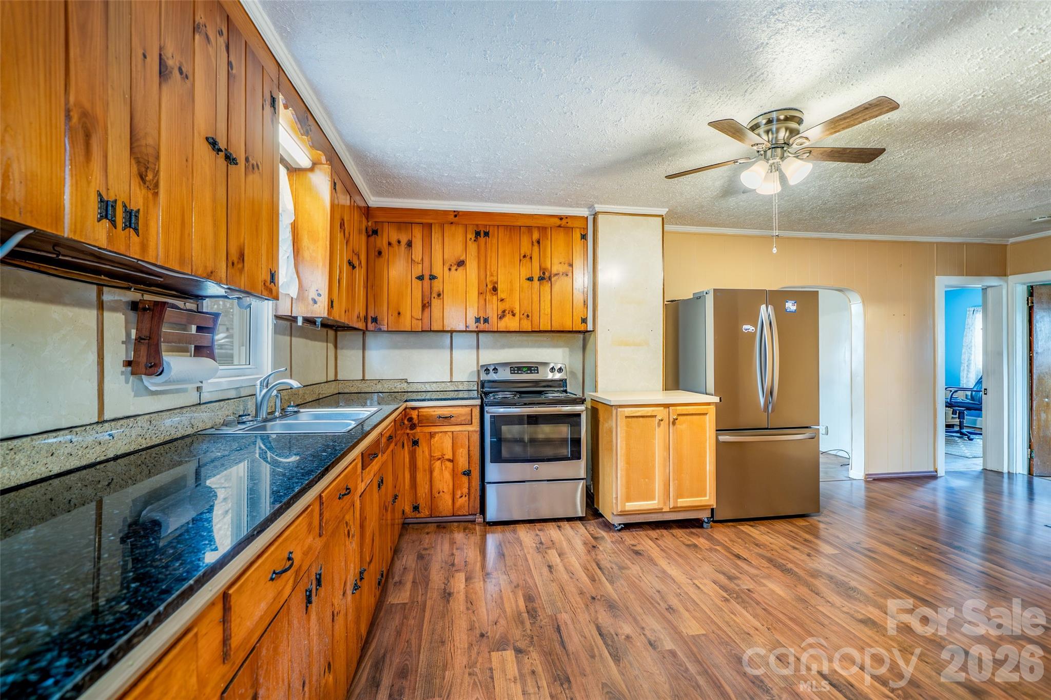 298 School Road East Asheville, NC 28803 - Photo 11 of 27 a kitchen with stainless steel appliances granite countertop wooden floors and sink