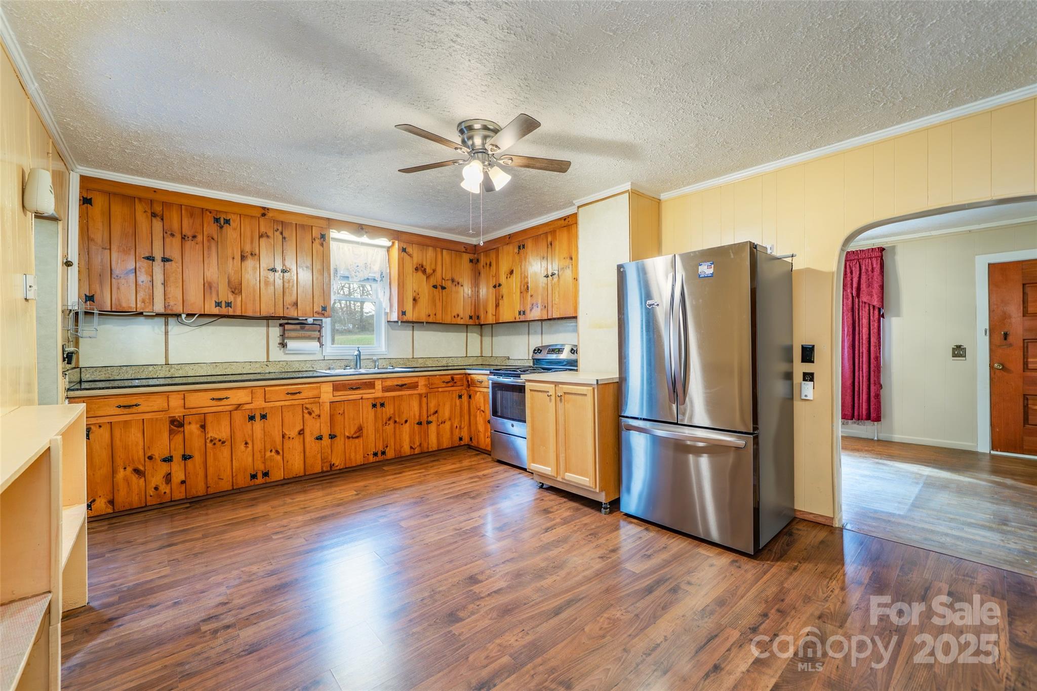 298 School Road East Asheville, NC 28803 - Photo 13 of 27 a kitchen with stainless steel appliances granite countertop a refrigerator a stove and a wooden floors