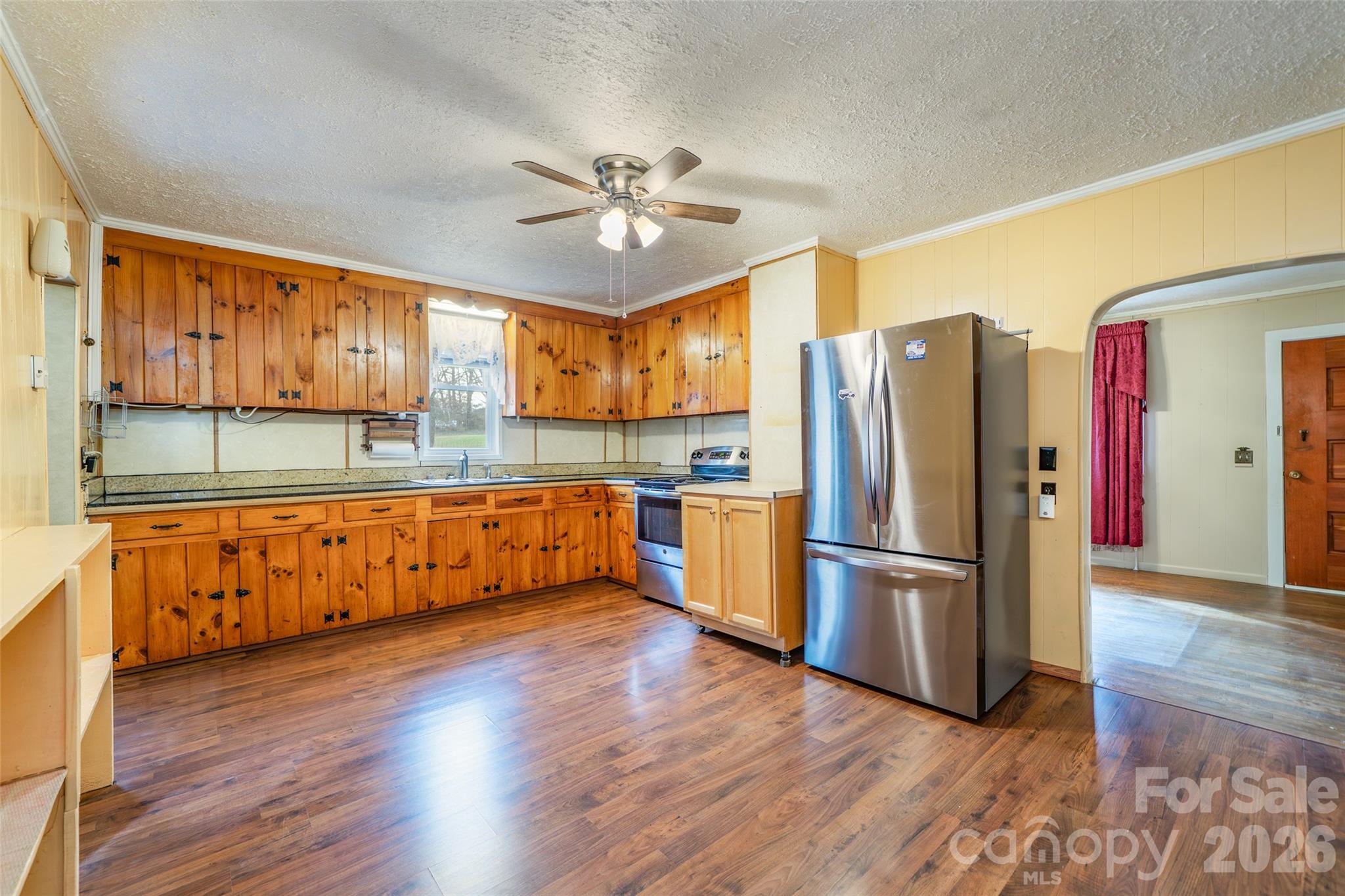 298 School Road East Asheville, NC 28803 - Photo 13 of 27 a kitchen with stainless steel appliances granite countertop a refrigerator a stove and a wooden floors