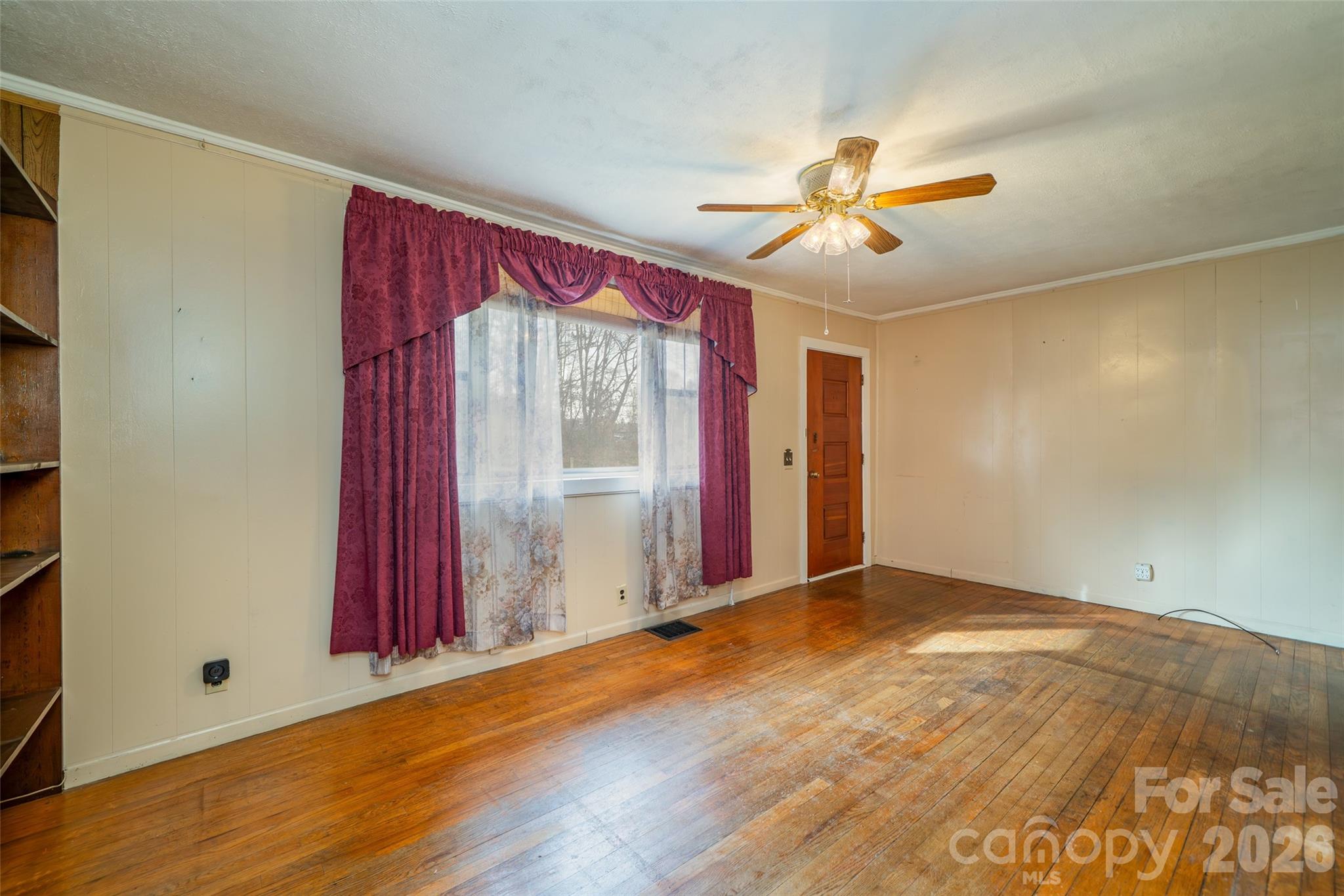 298 School Road East Asheville, NC 28803 - Photo 16 of 27 a view of empty room with wooden floor and fan