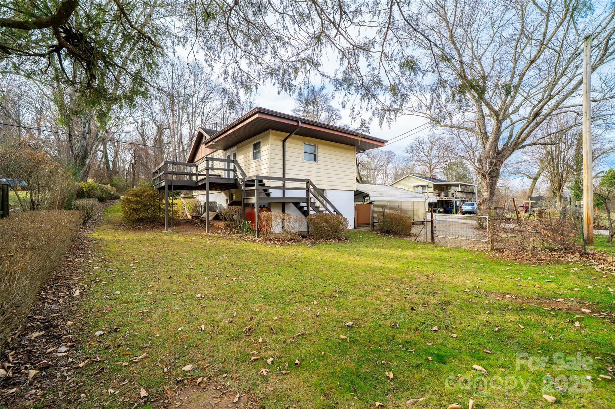298 School Road East Asheville, NC 28803 - Photo 27 of 27 a yellow house with trees in front of it