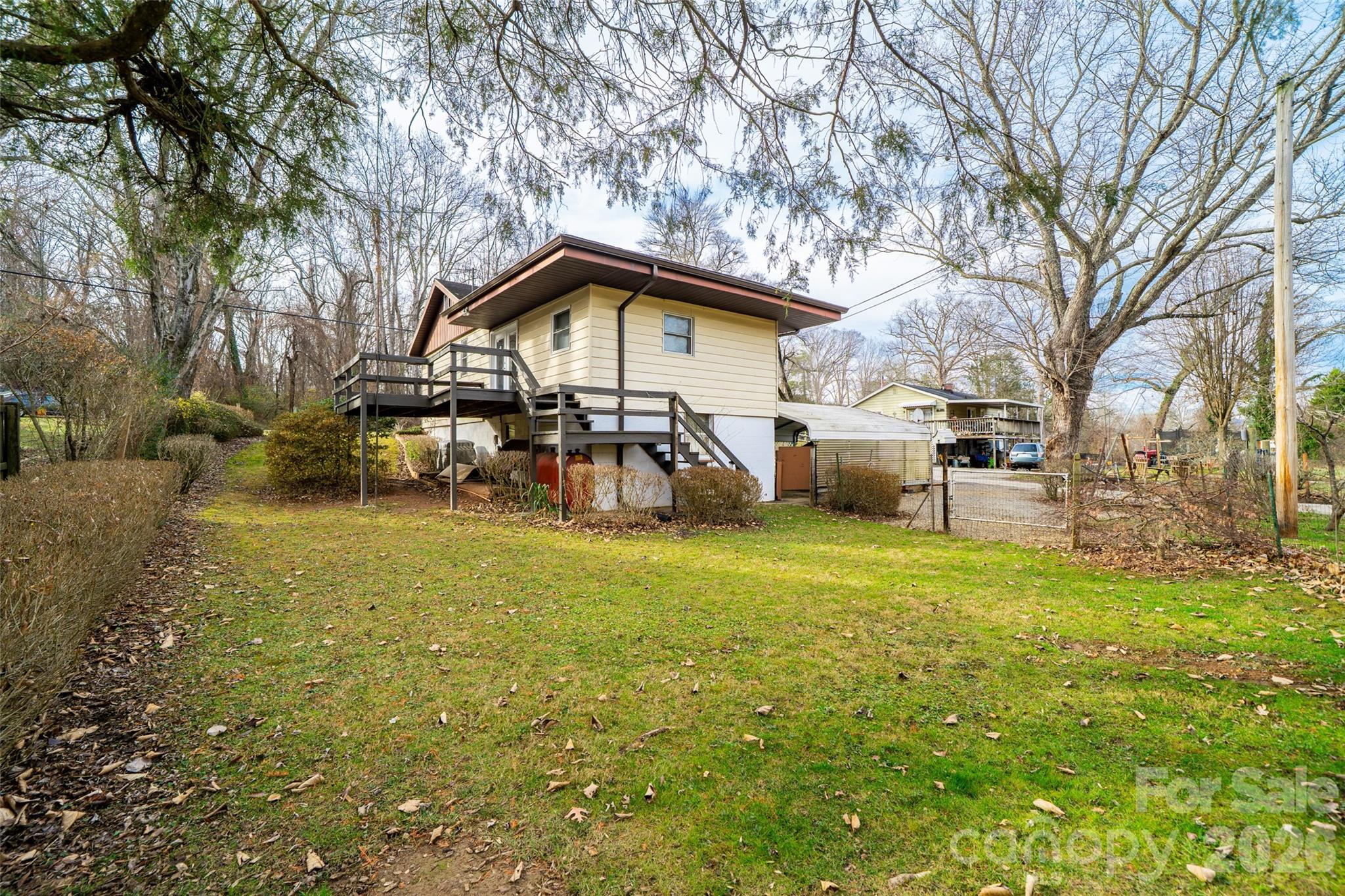 298 School Road East Asheville, NC 28803 - Photo 27 of 27 a yellow house with trees in front of it