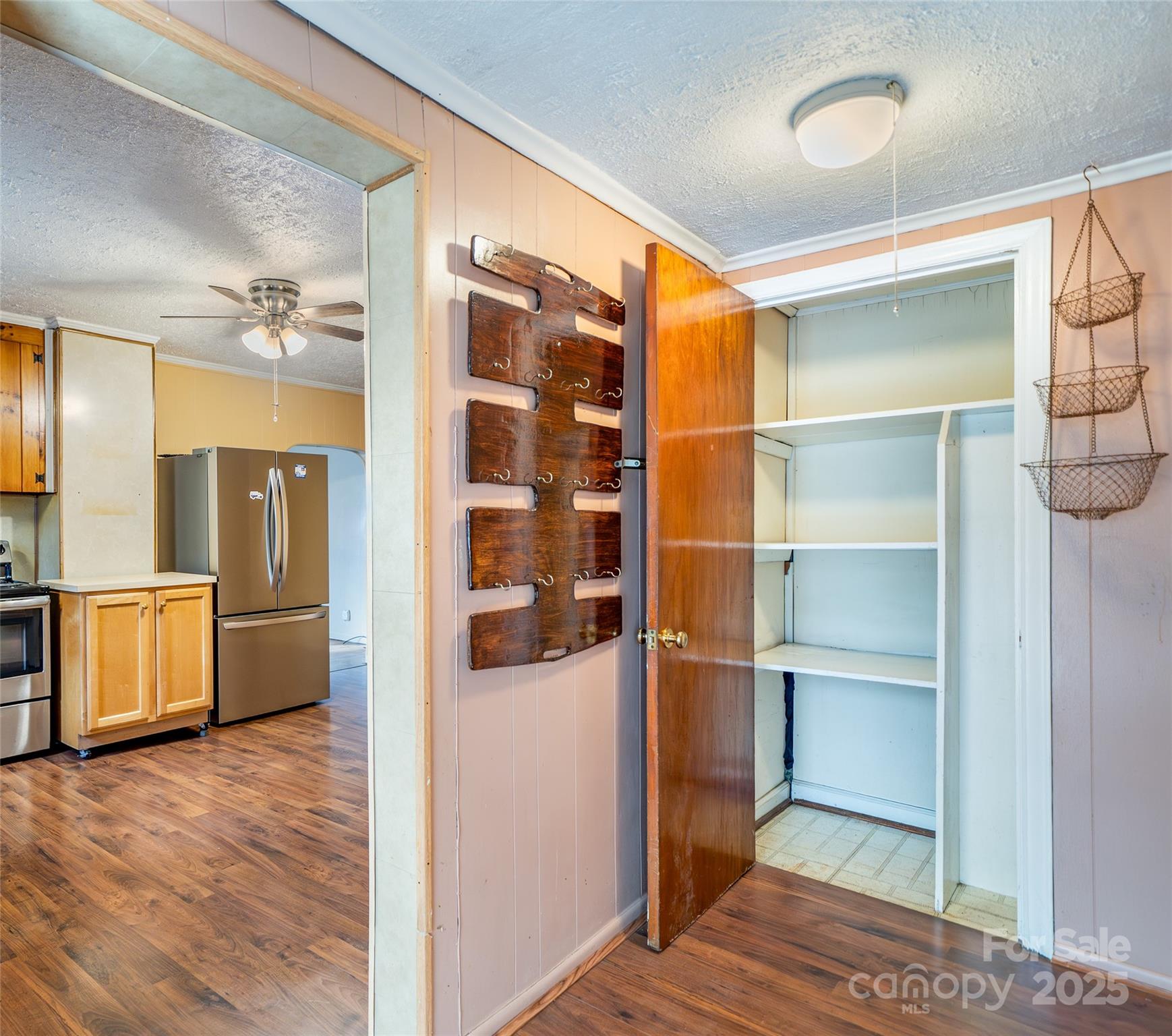 298 School Road East Asheville, NC 28803 - Photo 6 of 27 a hallway with walk in closet and wooden floor