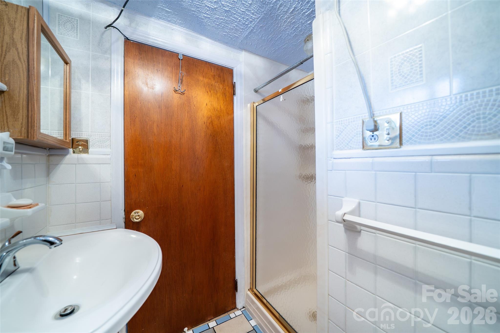 298 School Road East Asheville, NC 28803 - Photo 9 of 27 a bathroom with a sink and shower