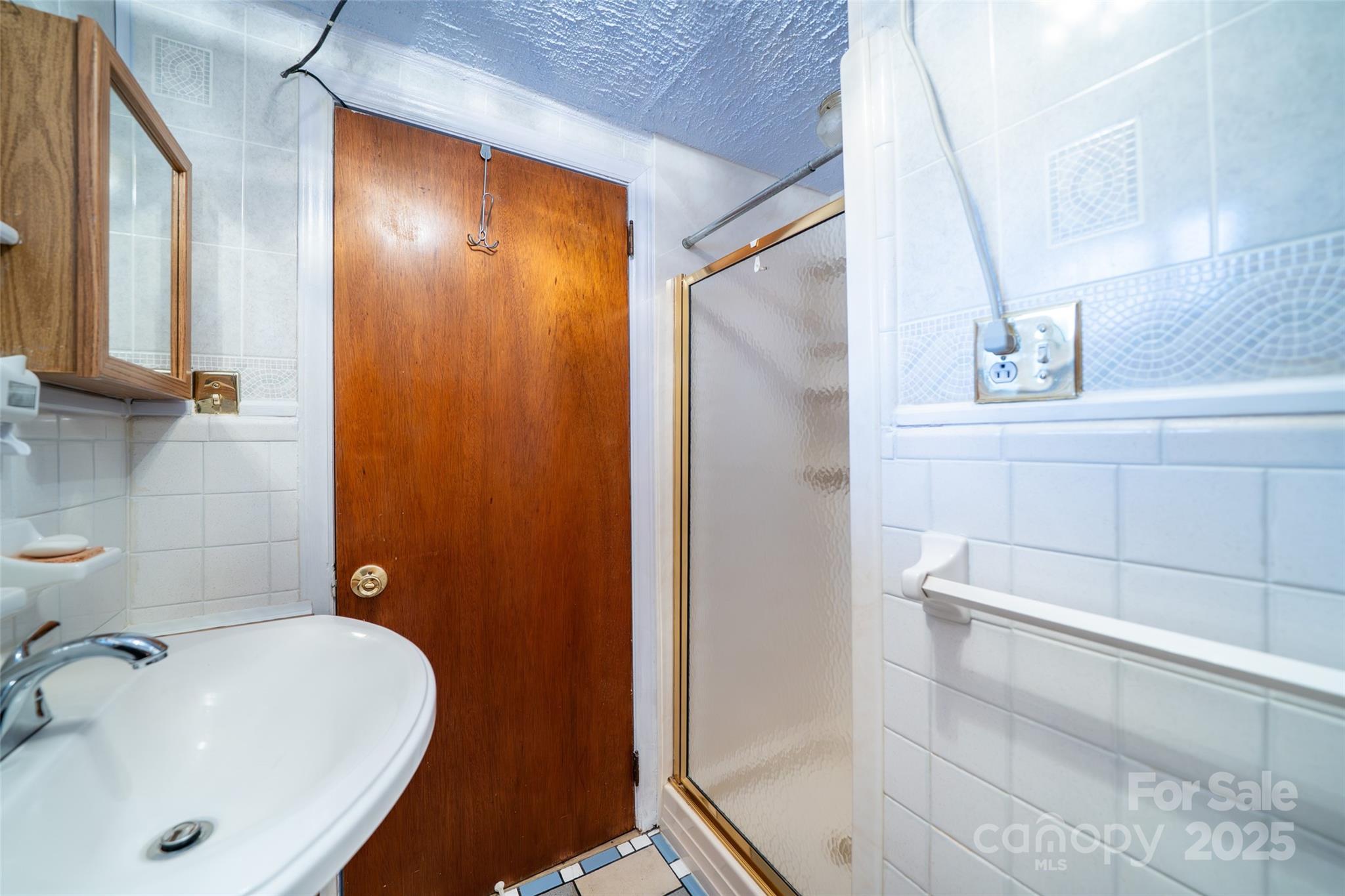 298 School Road East Asheville, NC 28803 - Photo 9 of 27 a bathroom with a sink and shower