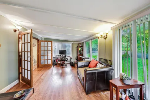 a living room filled with furniture and floor to ceiling windows