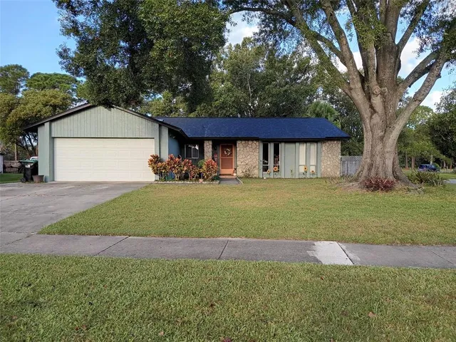 a front view of a house with a garden and yard
