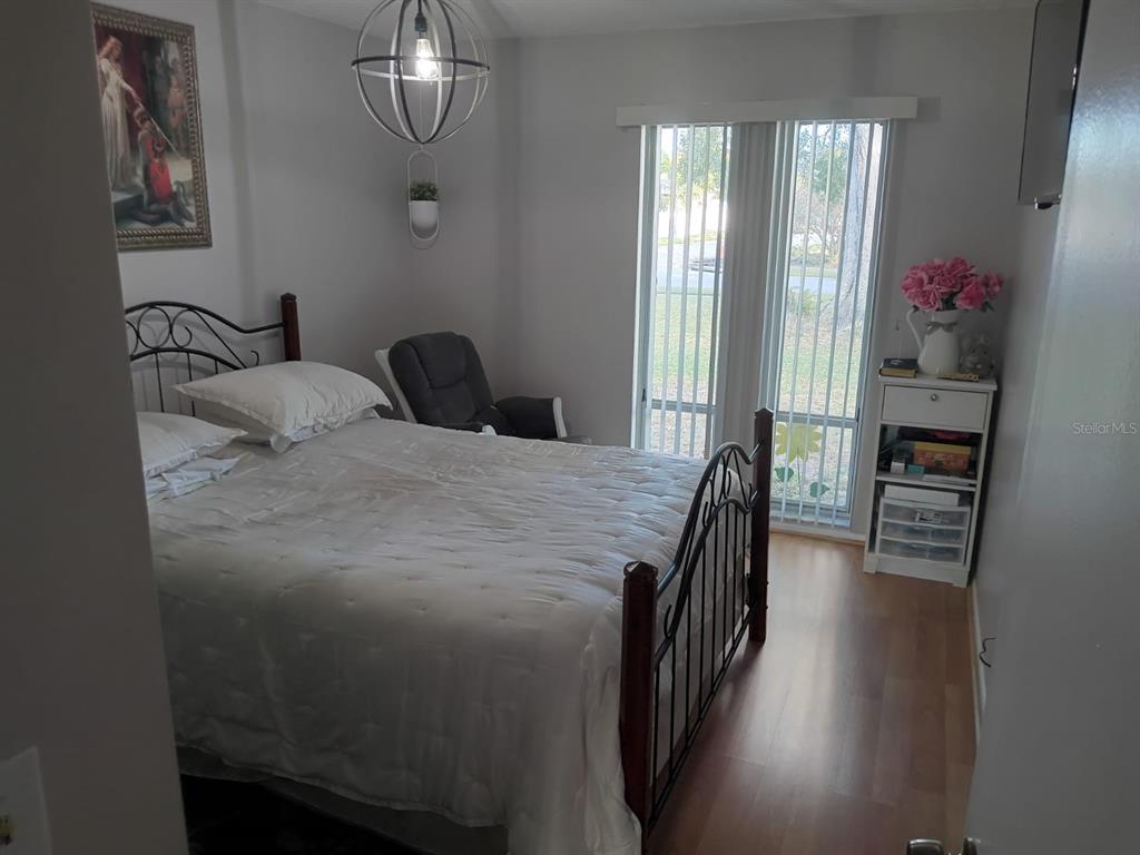 10700 Gardenwood Road Orlando, FL 32837 - Photo 14 of 23 a bedroom with a bed and a chandelier