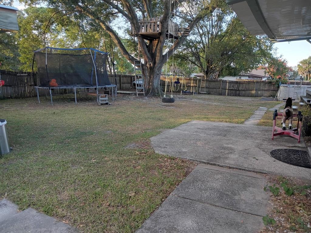 10700 Gardenwood Road Orlando, FL 32837 - Photo 19 of 23 a view of a park with bench and trees