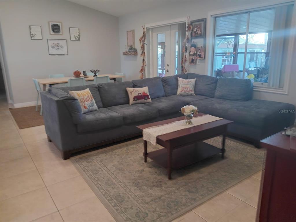 10700 Gardenwood Road Orlando, FL 32837 - Photo 6 of 23 a living room with furniture and a couch
