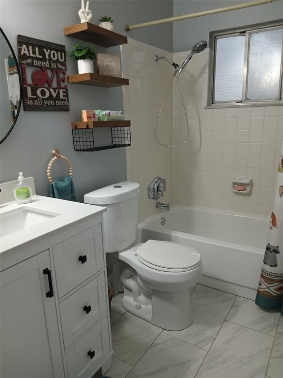 10700 Gardenwood Road Orlando, FL 32837 - Photo 10 of 23 a bathroom with a sink toilet and shower