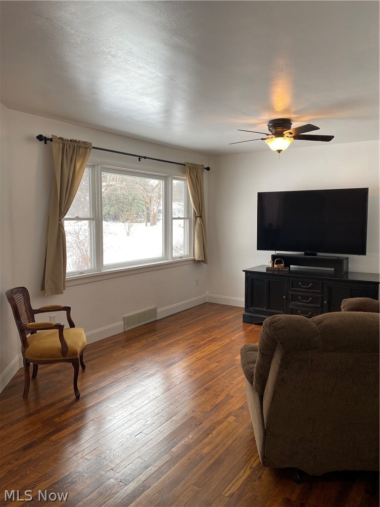 4115 South Ridge Road East Ashtabula, OH 44004 - Photo 6 of 35 Living room 21 x 12 with hardwood flooring and ceiling fan.