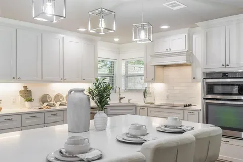 a kitchen with stainless steel appliances kitchen island granite countertop a sink and cabinets