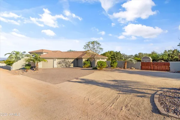 a view of a porch with chairs and a yard