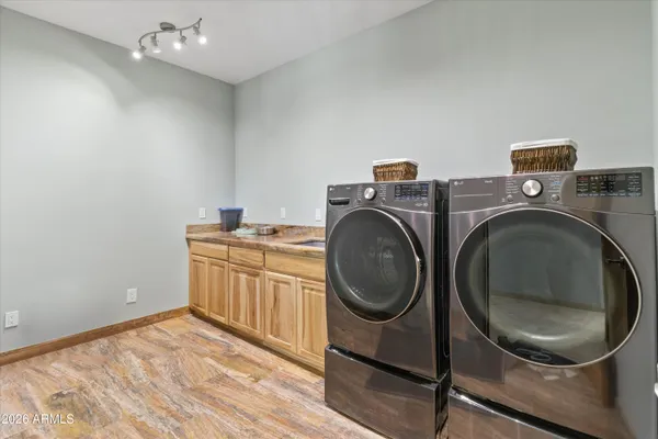 a kitchen with stainless steel appliances granite countertop a sink and a refrigerator