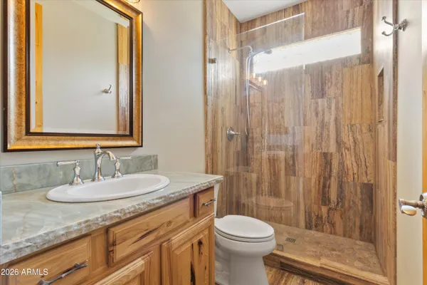 a kitchen with stainless steel appliances granite countertop a sink a stove and a refrigerator