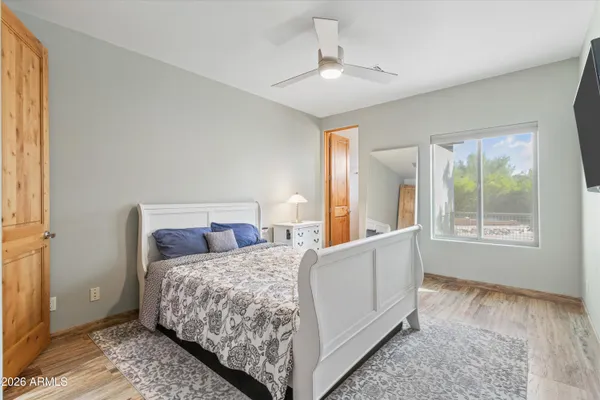 a bedroom with a bed and a flat screen tv