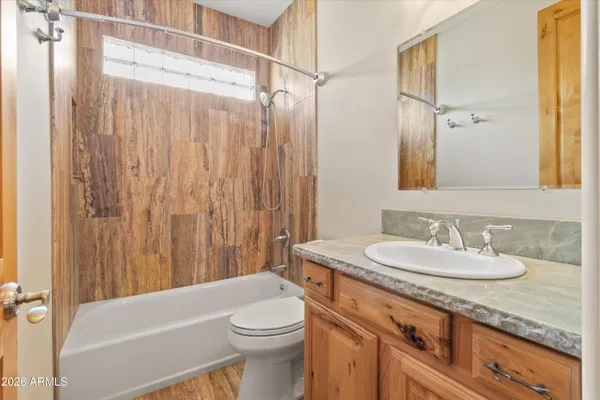 a bathroom with a sink double vanity granite and a mirror