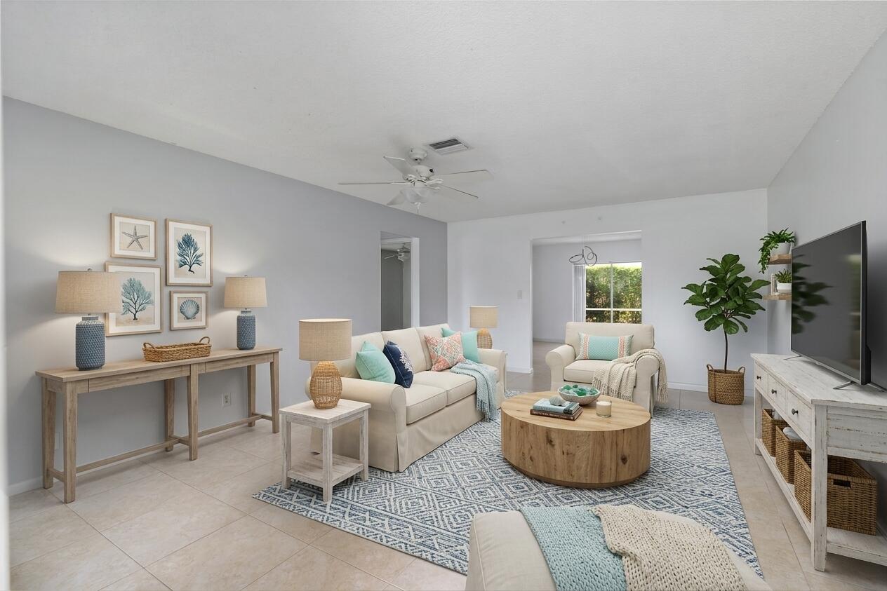 22707 Southwest 64th Way Boca Raton, FL 33428 - Photo 12 of 22 a living room with furniture a fireplace and a flat screen tv