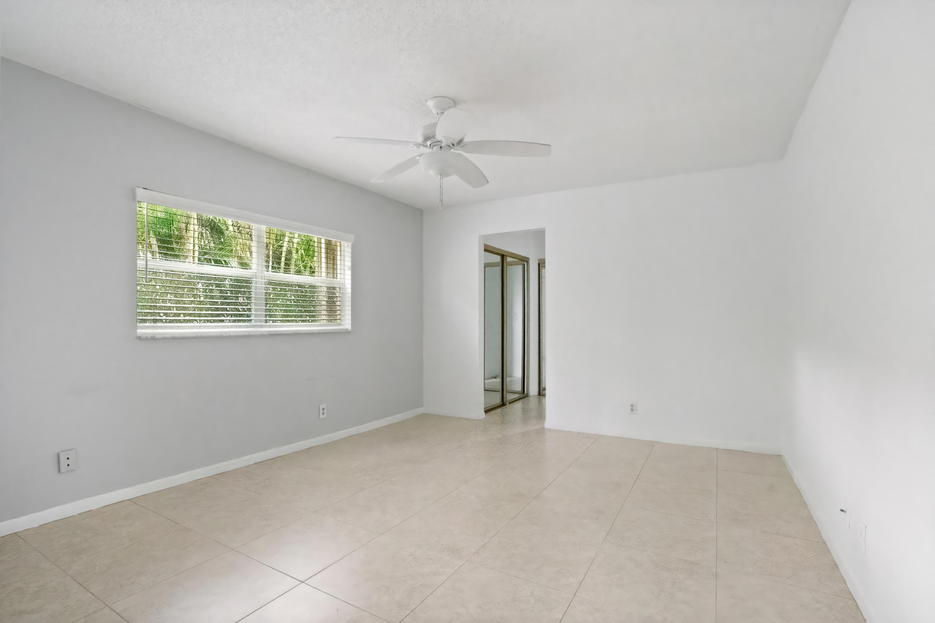 22707 Southwest 64th Way Boca Raton, FL 33428 - Photo 17 of 22 an empty room with windows and fan