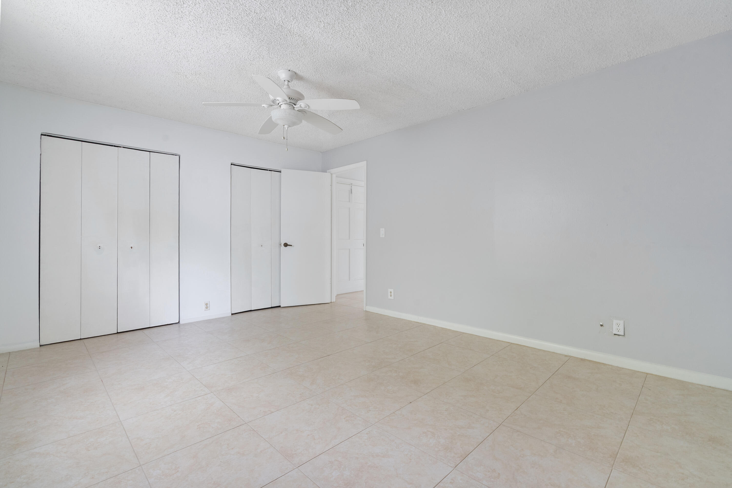 22707 Southwest 64th Way Boca Raton, FL 33428 - Photo 21 of 22 a view of an empty room and chandelier fan