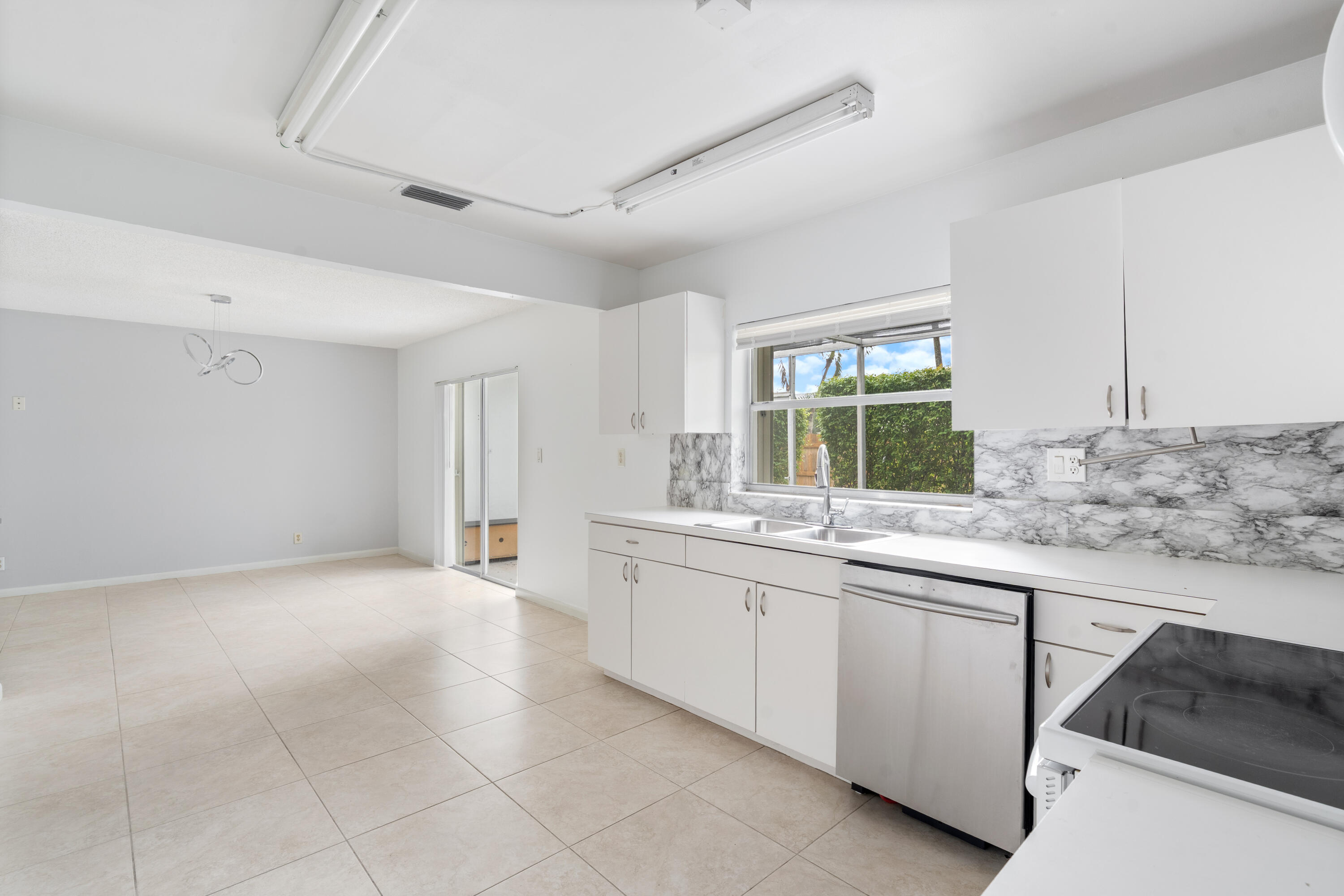 22707 Southwest 64th Way Boca Raton, FL 33428 - Photo 8 of 22 a kitchen with a sink and cabinets