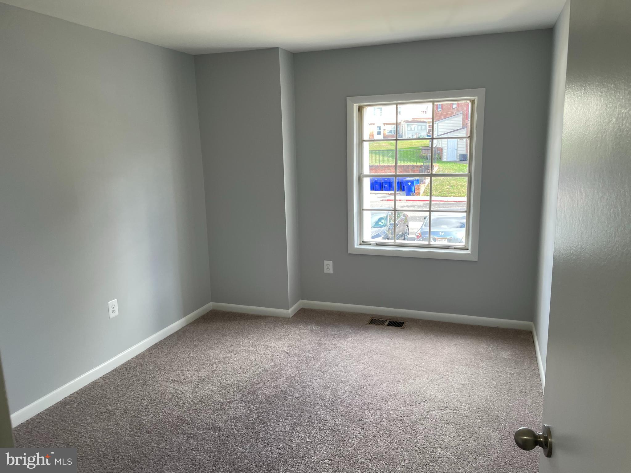 9220 Bridle Path Lane, Unit E Laurel, MD 20723 - Photo 12 of 14 an empty room with a window