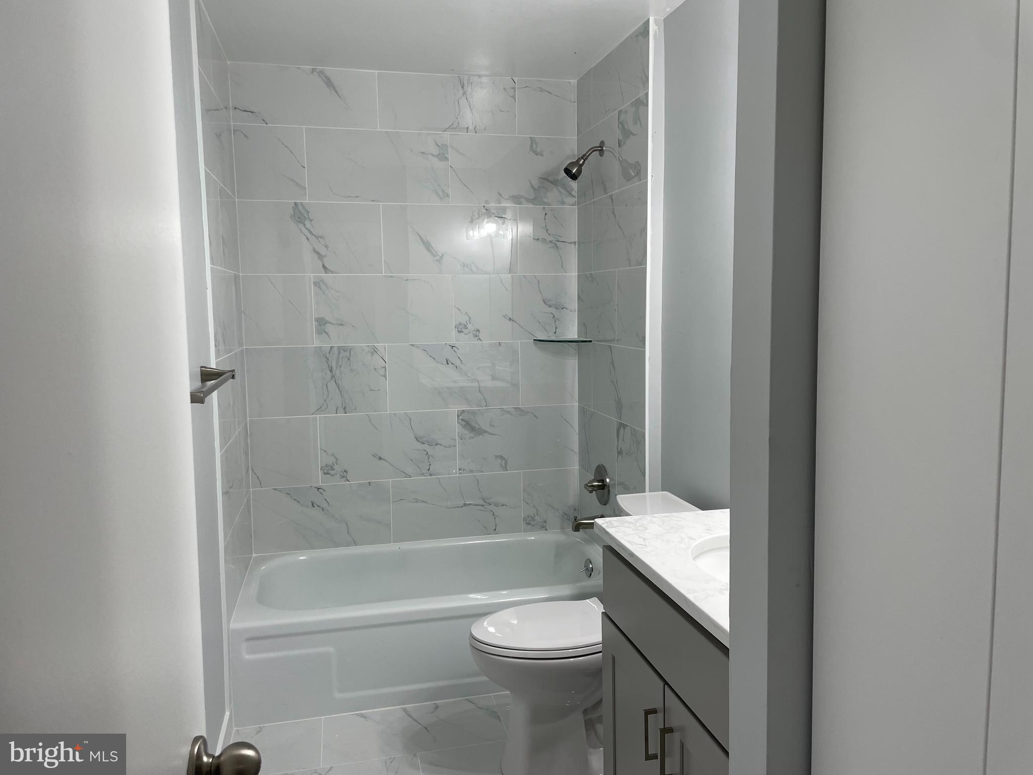 9220 Bridle Path Lane, Unit E Laurel, MD 20723 - Photo 13 of 14 a bathroom with a shower and a toilet
