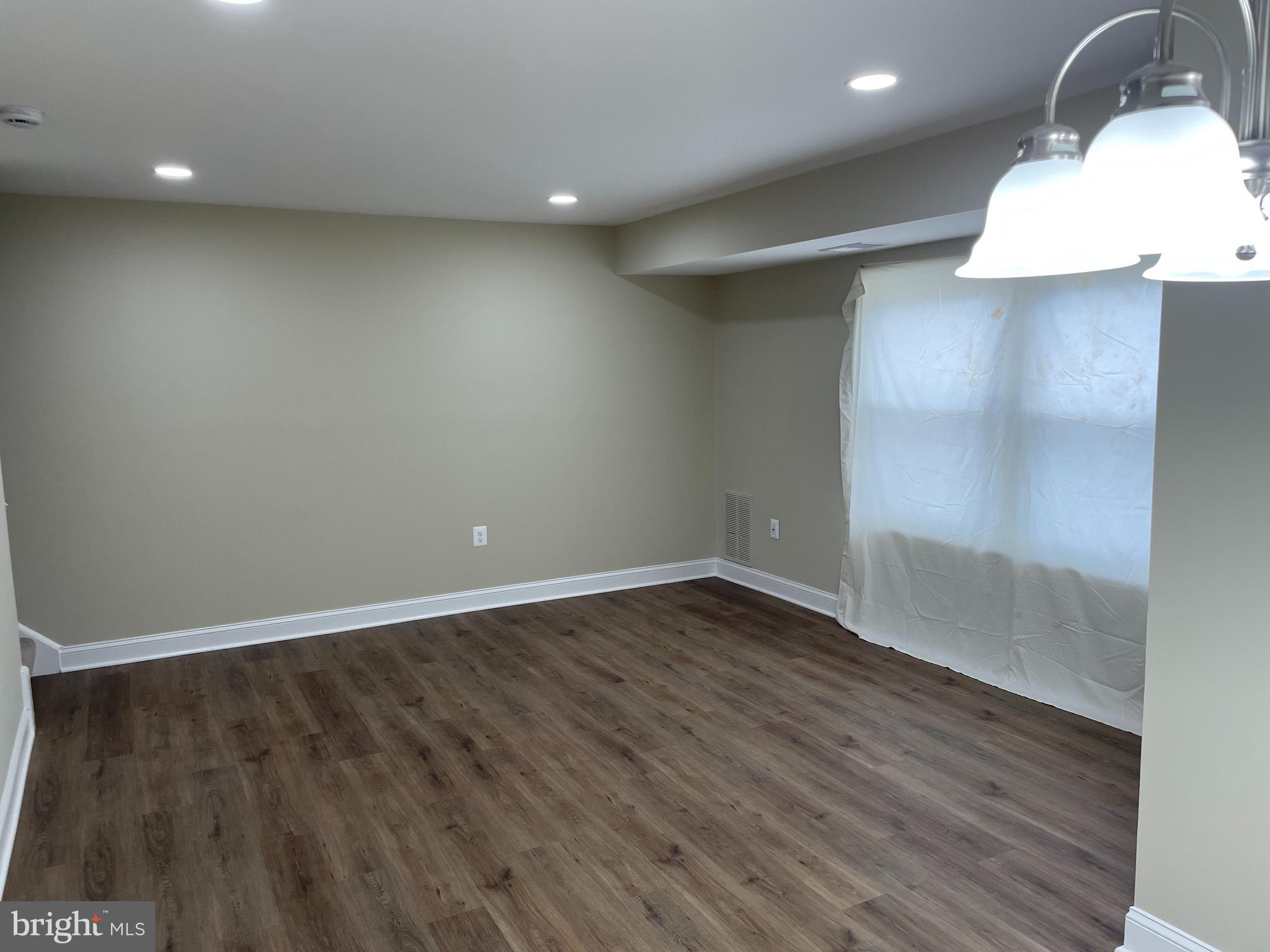 9220 Bridle Path Lane, Unit E Laurel, MD 20723 - Photo 8 of 14 a view of an empty room with wooden floor