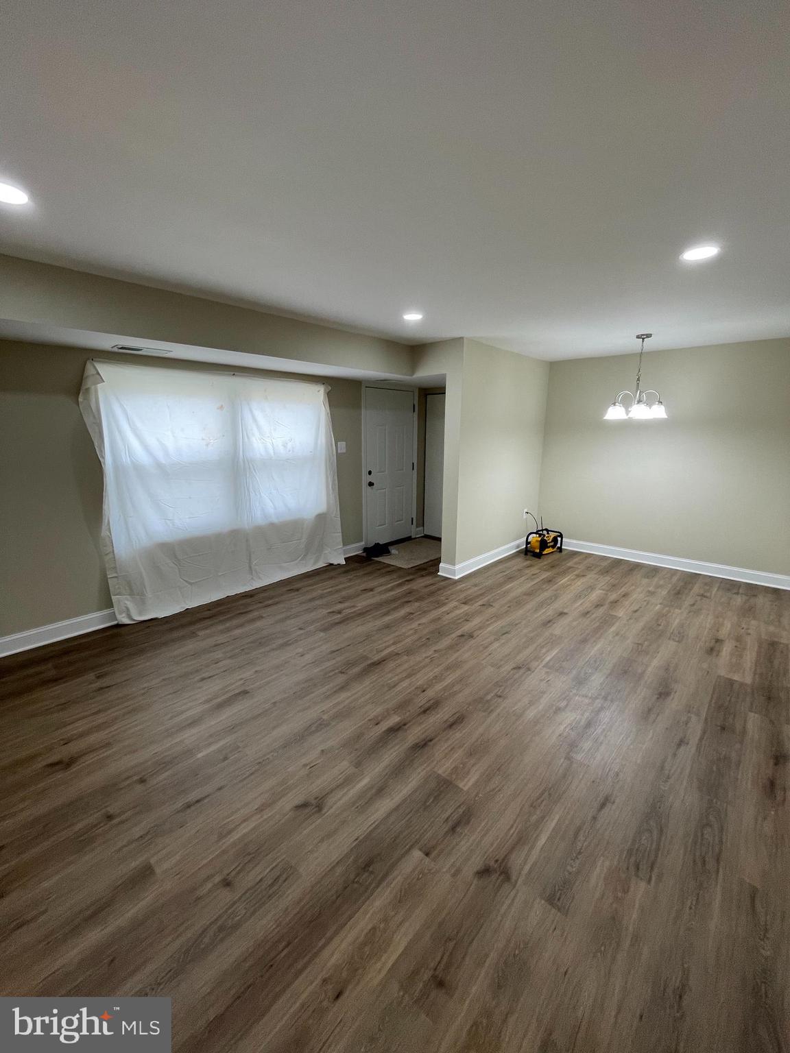9220 Bridle Path Lane, Unit E Laurel, MD 20723 - Photo 9 of 14 an empty room with wooden floor and windows