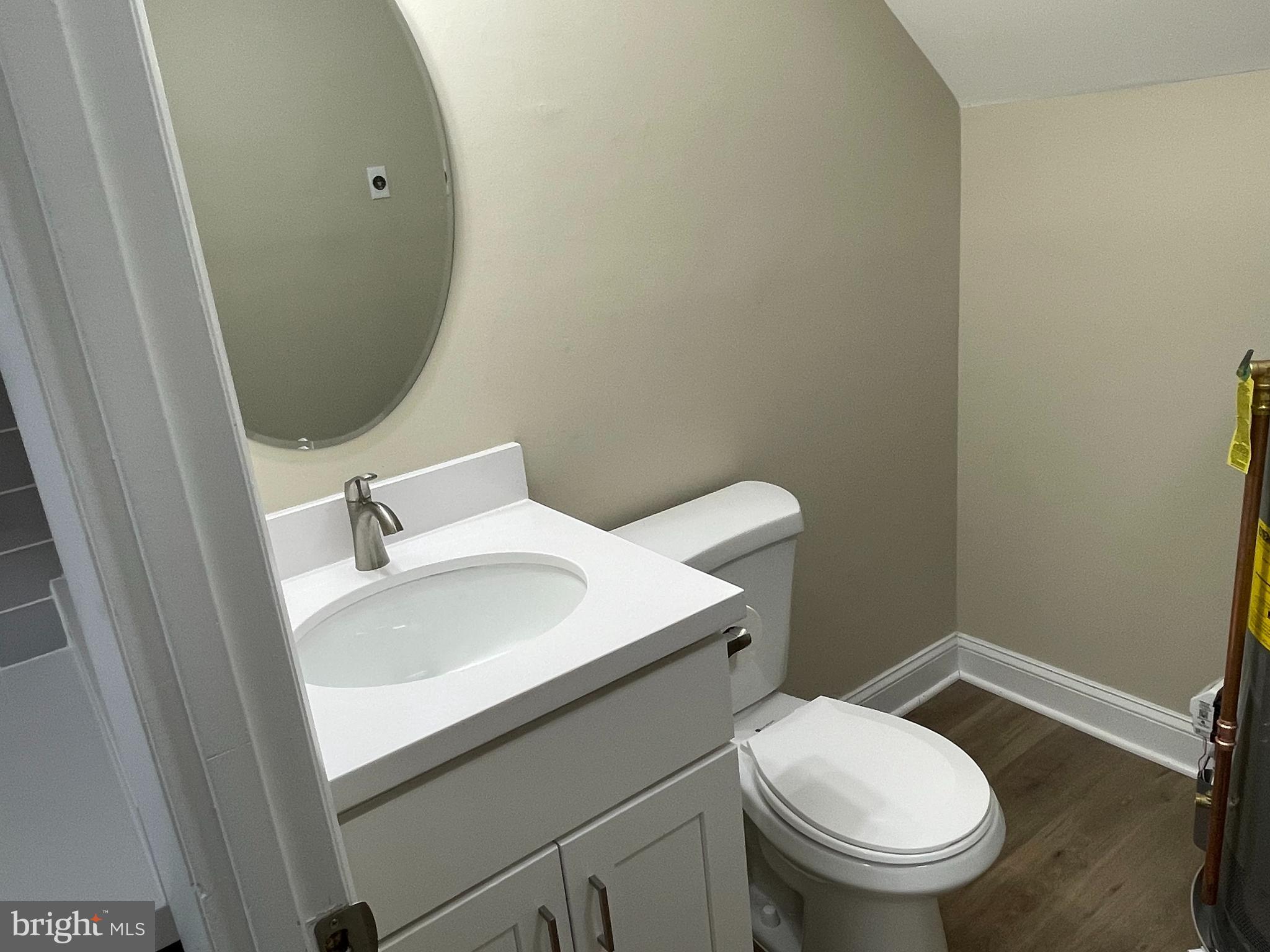 9220 Bridle Path Lane, Unit E Laurel, MD 20723 - Photo 10 of 14 a bathroom with a sink a toilet and a mirror