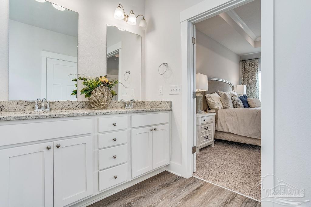 7767 Saddlebrook Avenue Pace, FL 32571 - Photo 24 of 28 a en suite bathroom with a granite countertop sink and a mirror