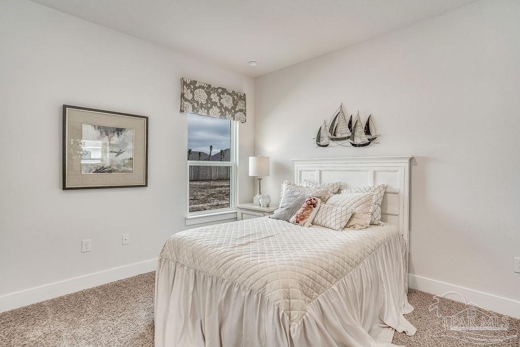 7767 Saddlebrook Avenue Pace, FL 32571 - Photo 4 of 28 a bedroom with a bed and painting on the wall