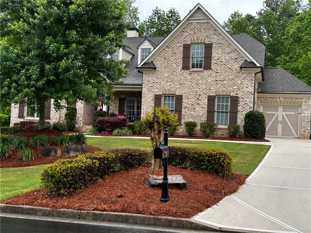 a front view of house with yard and green space