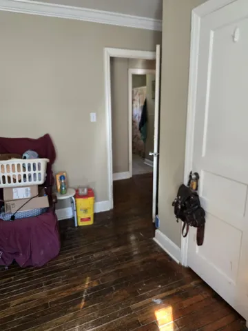 a room with wooden floor and gym equipment