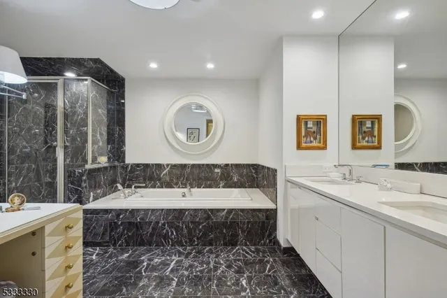 a living room with furniture a chandelier and a dining table