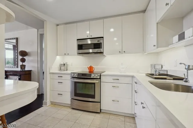 a kitchen with cabinets appliances and a sink